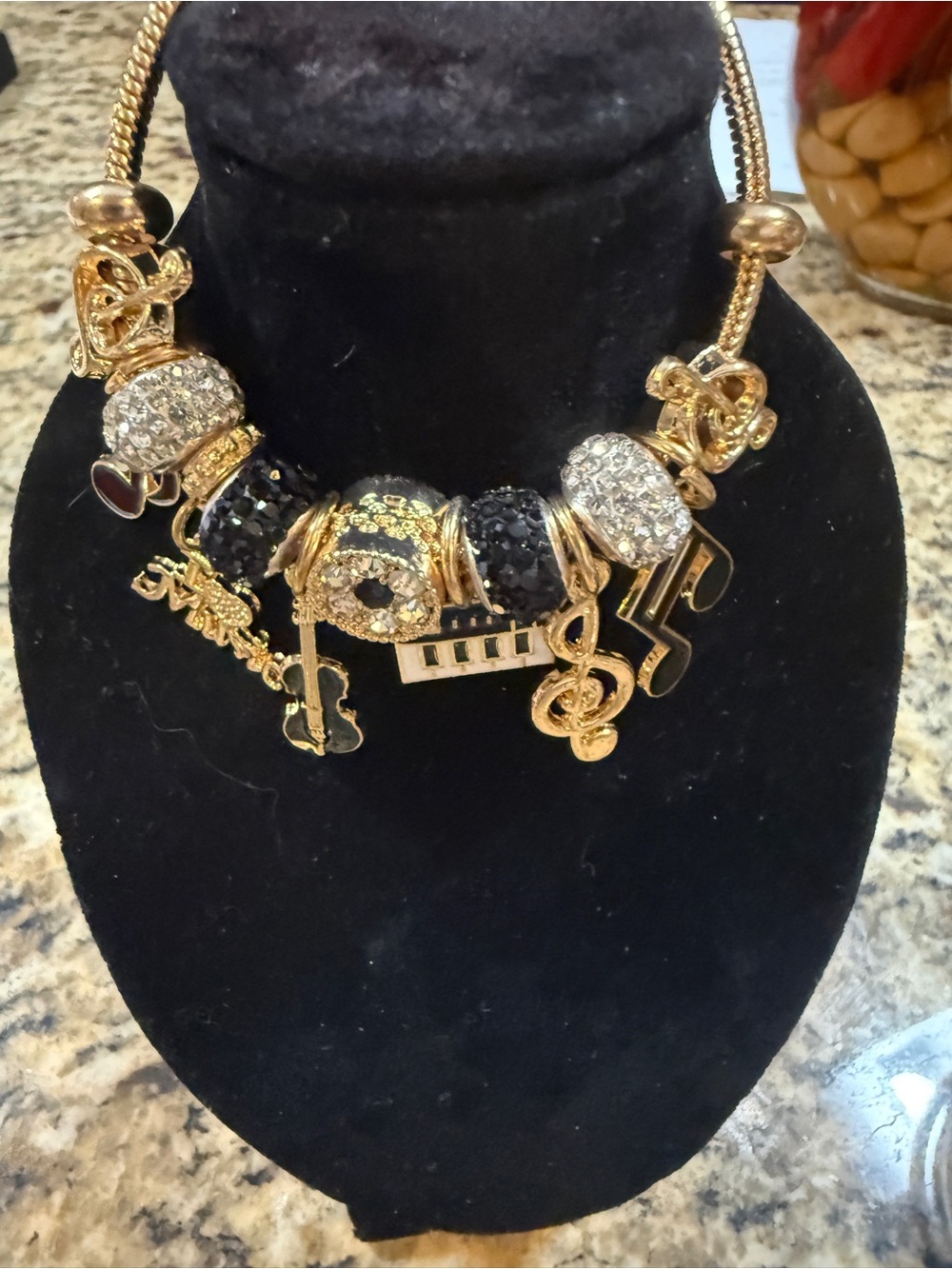 Gold-Tone Music Charm Bracelet with Black and Clear Accents